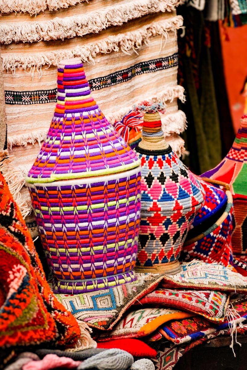 Vibrant handcrafted baskets and textiles displayed in Marrakech market, highlighting traditional Moroccan craftsmanship.