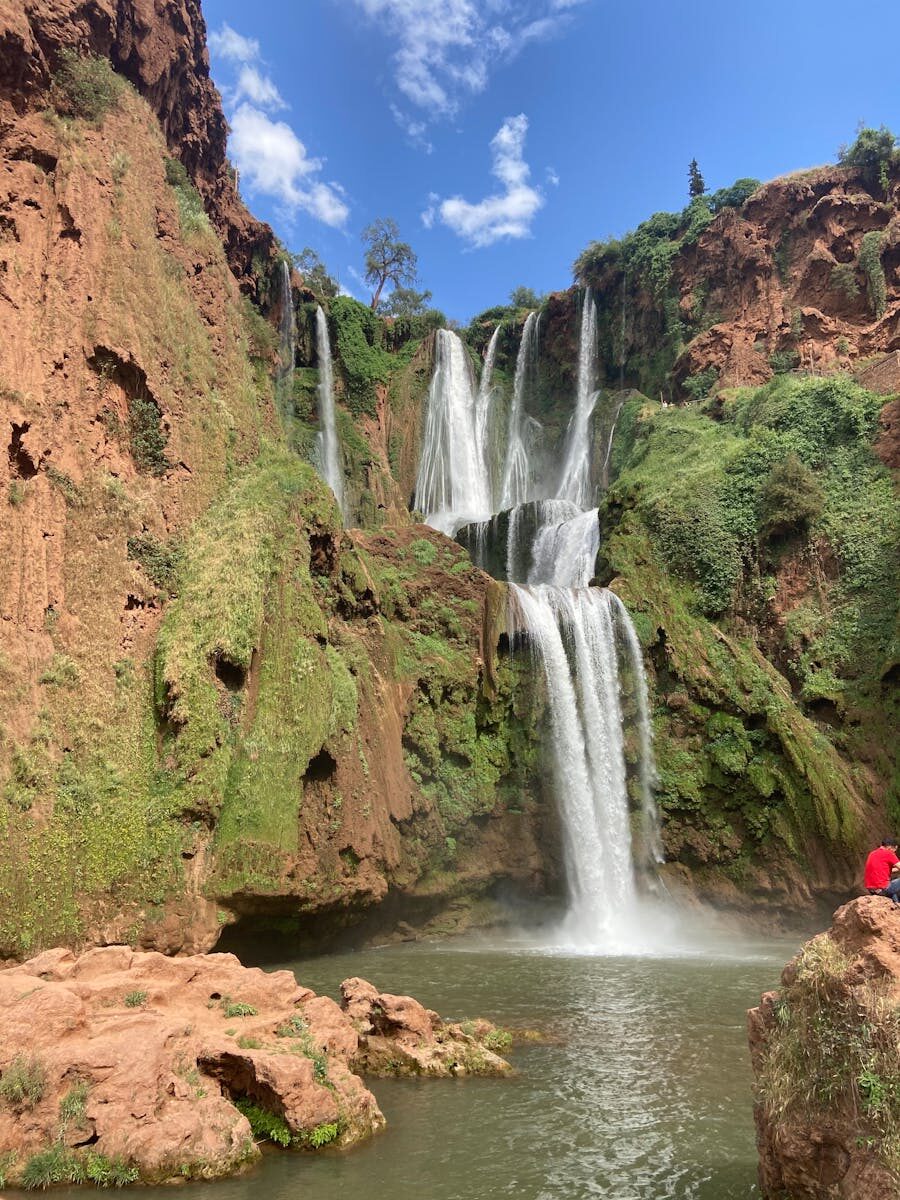 Breathtaking view of the Ouzoud Waterfalls cascading into the pool in Morocco's Atlas Mountains.